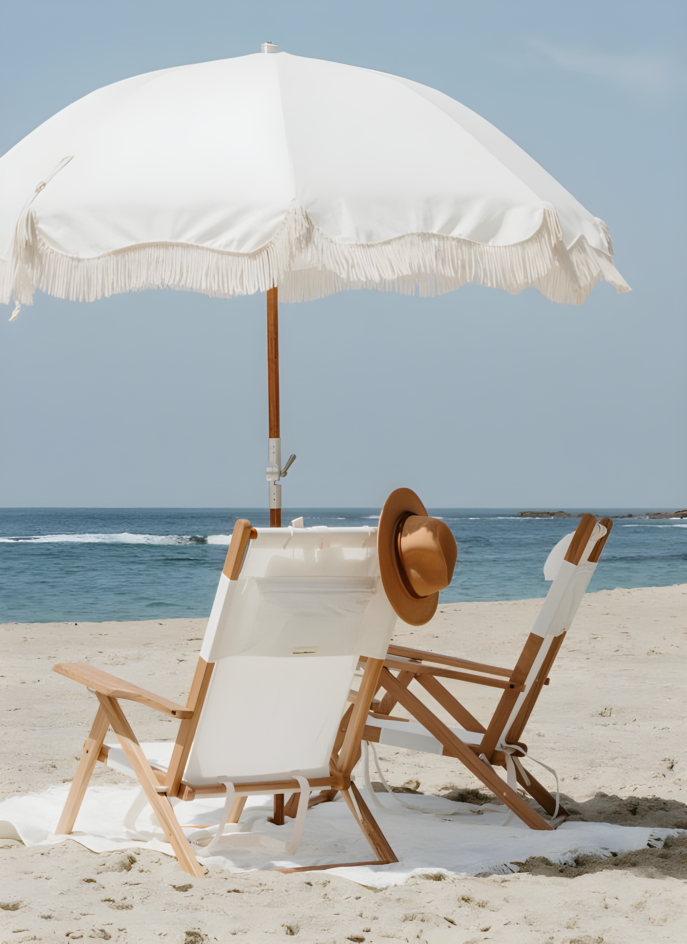 Luxury beachside setup with sustainable deck chairs and an elegant umbrella.